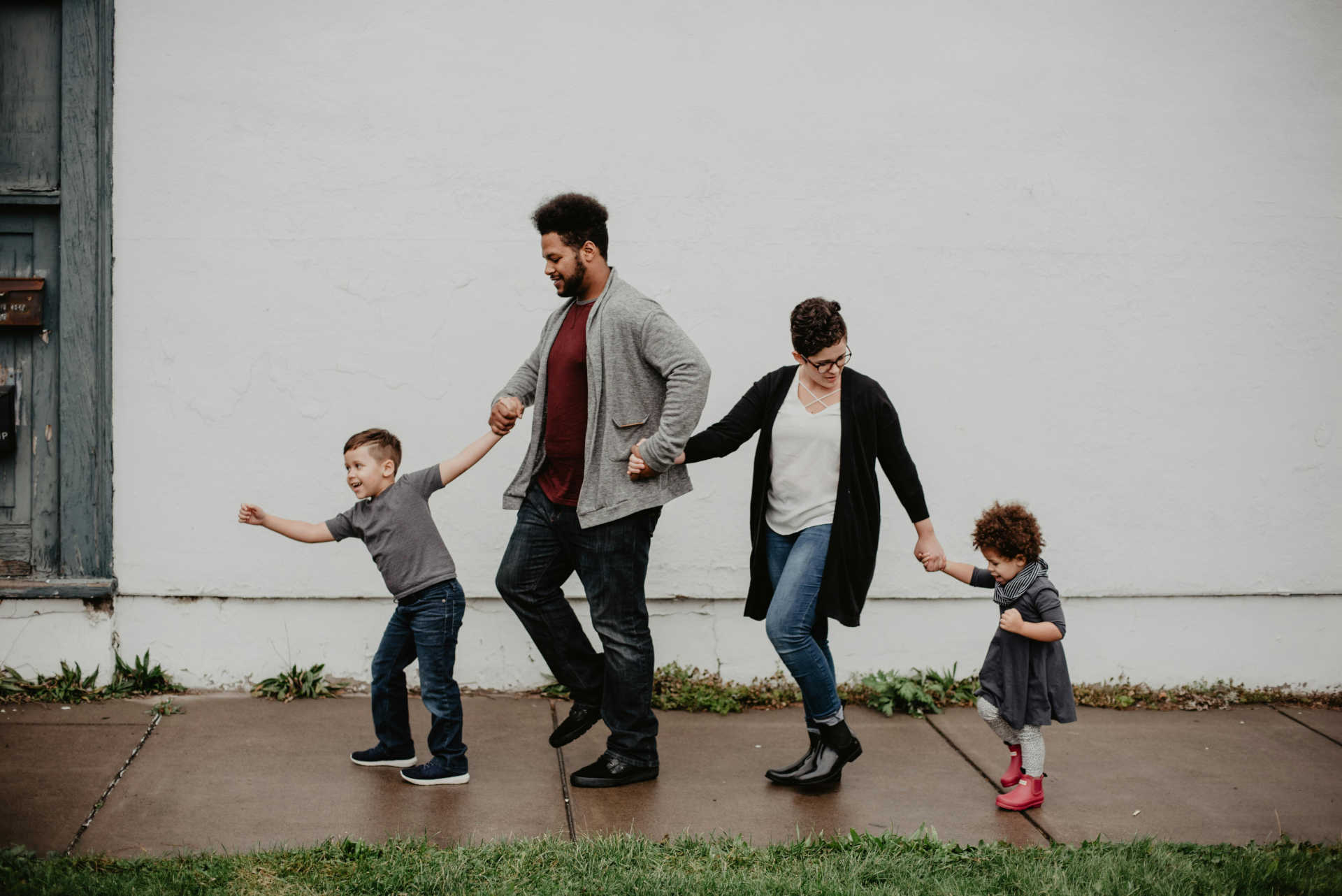 A foster family walking together, holding hands